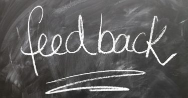 Dentist using patient feedback as written on this chalk board