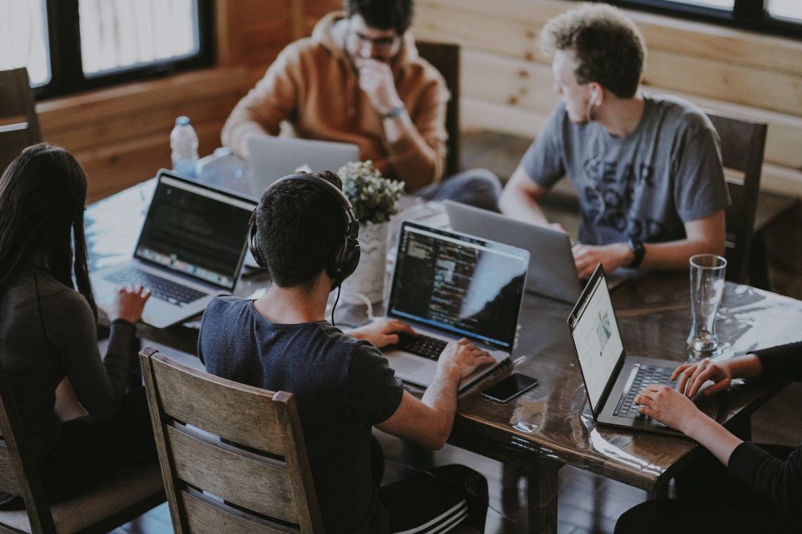 A group of people at a desk looking at online reviews