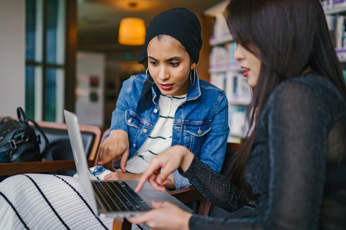Two young professionals working on their business's conversion rate optimization strategy.
