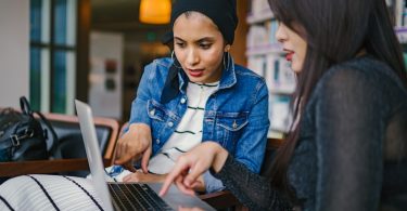 Two young professionals working on their business's conversion rate optimization strategy.