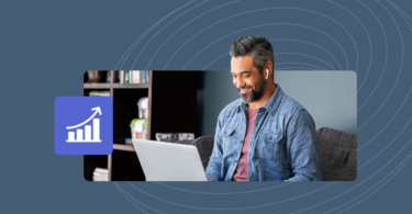An online reputation management consultant looking at his laptop computer and smiling