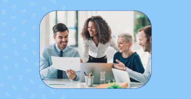 Image shows a sales team using AI-driven reports to understand their performance