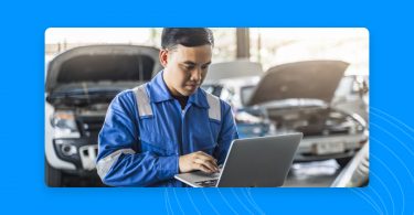 Image of an auto professional looking at a laptop