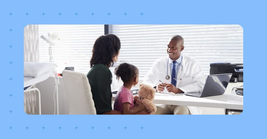 A doctor and his patients talking during a visit that was setup by a medical appointment scheduler.