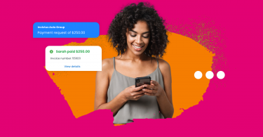 SMS payments - a woman making a payment on her mobile device