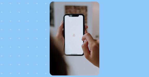 Phone opening the Airbnb app.