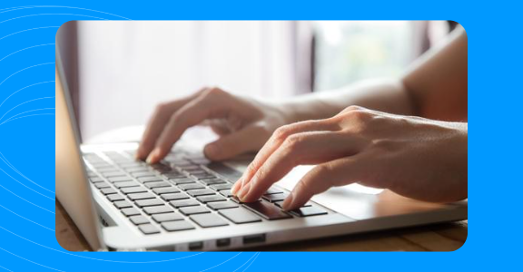 Freelance writer typing on a laptop.