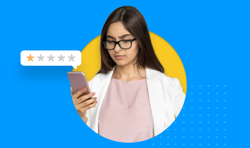 A woman looking at her phone reading a one-star review