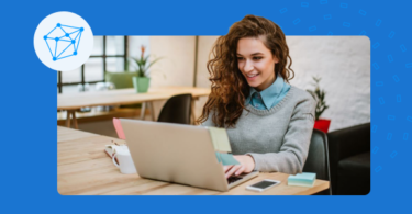 Woman sitting at a table using her laptop