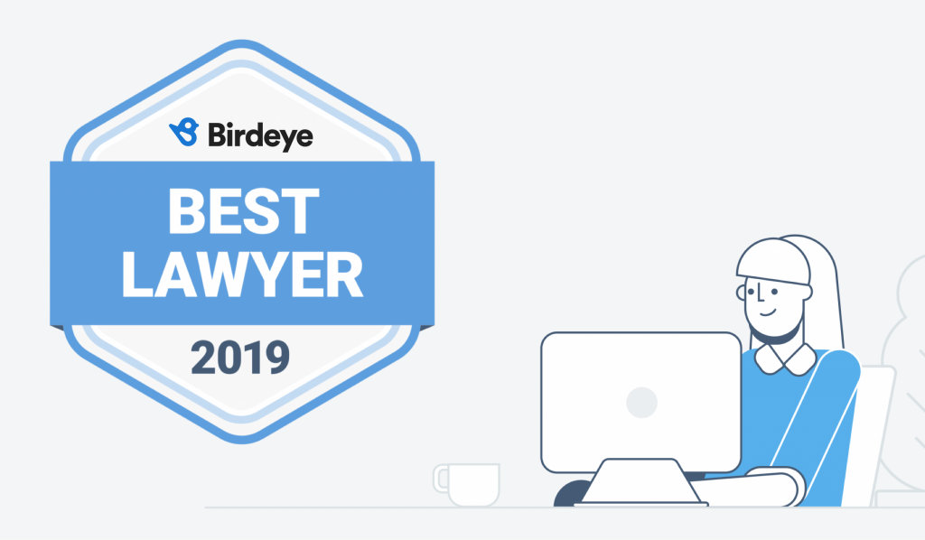 Birdeye Best Lawyer of 2019 badge, part of Birdeye Badges program, floating next to a female law professional.