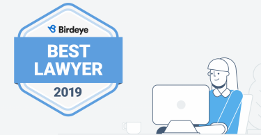 Birdeye Best Lawyer of 2019 badge, part of Birdeye Badges program, floating next to a female law professional.